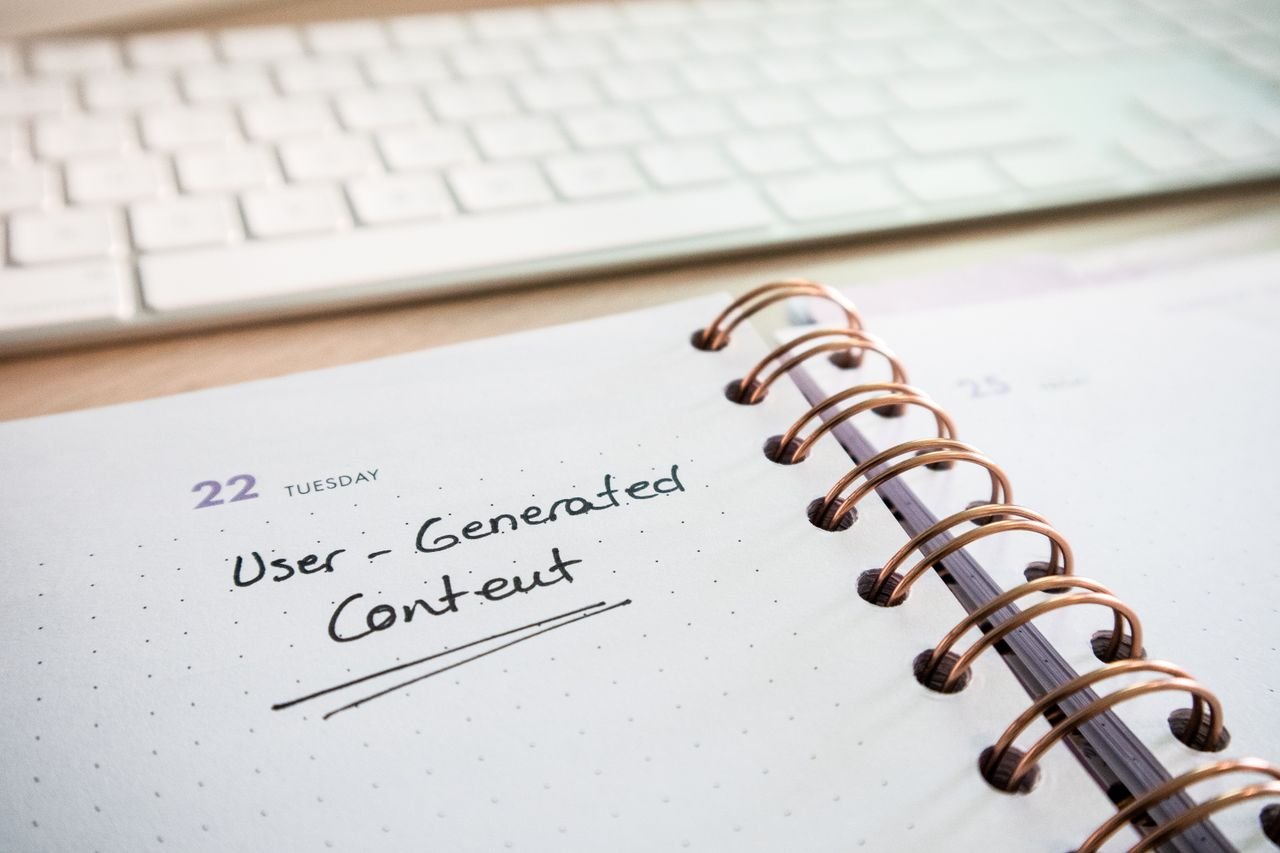 Notebook with user-generated content note and keyboard, ideal for planning and productivity.
